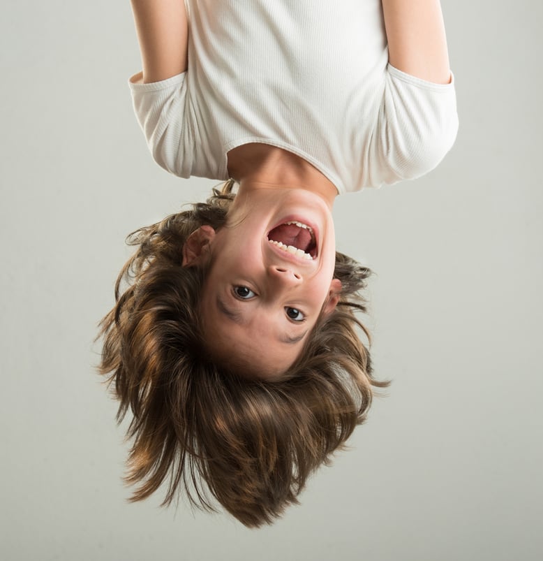 Little boy hanging upside down